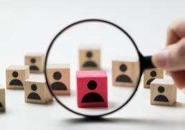 Searching for talent or looking for employee concept using magnifying glass and wooden cube with people icon